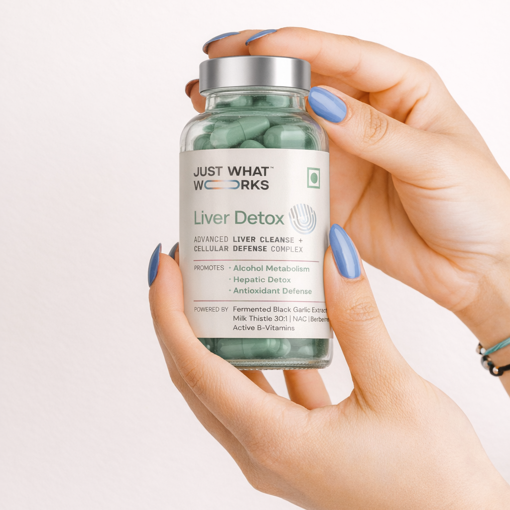 Hand holding a bottle of 'Just What You Need' Liver Detox supplement against a light background