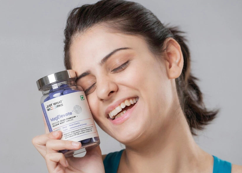 Woman holding a bottle of 'Magic Vitamins' with a gray background