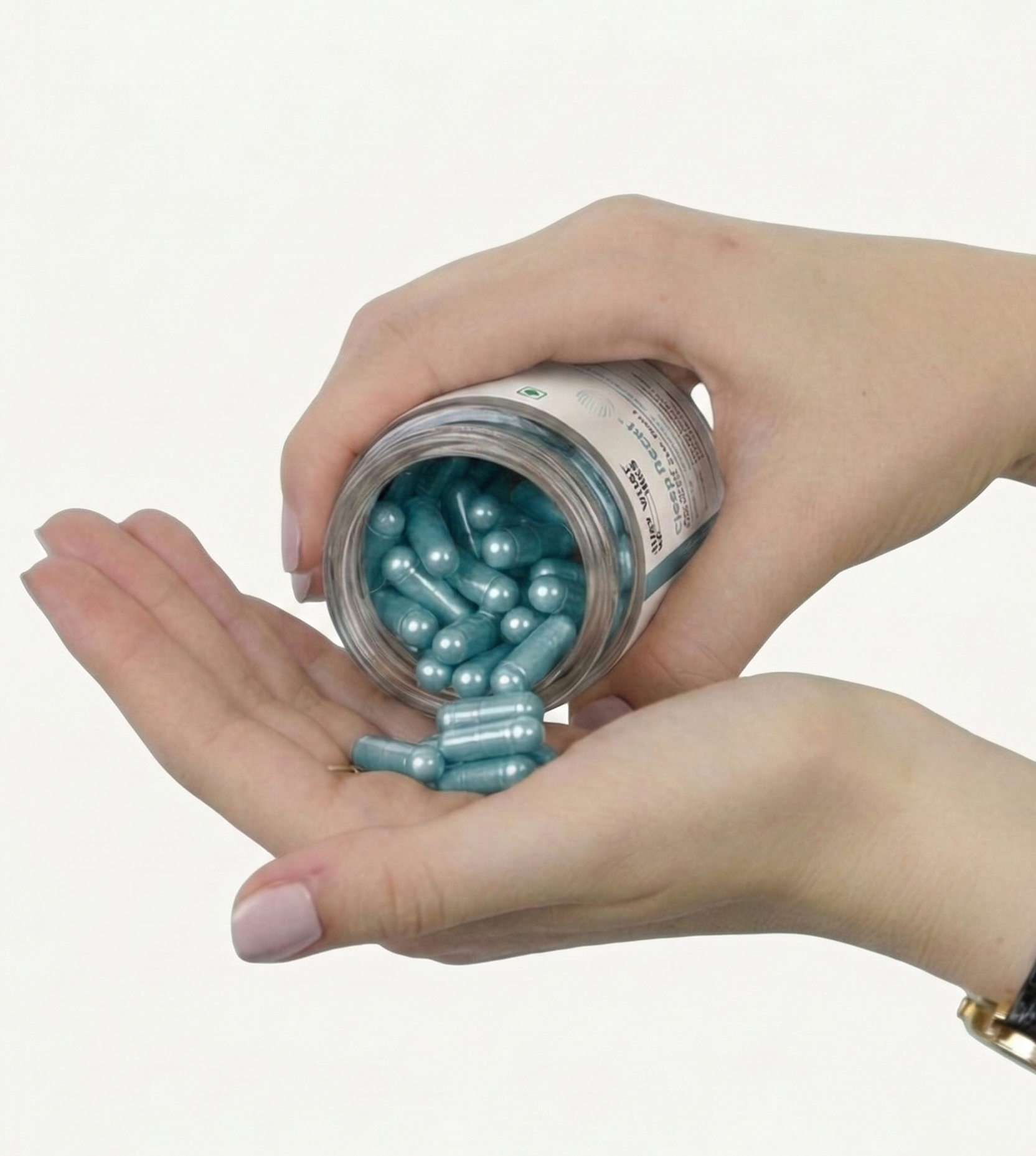 Hand holding a jar of sleep reset capsules with a white background