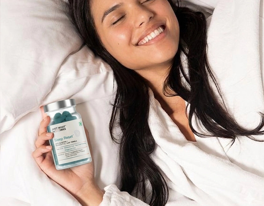 Woman lying in bed holding a supplement container with a white background
